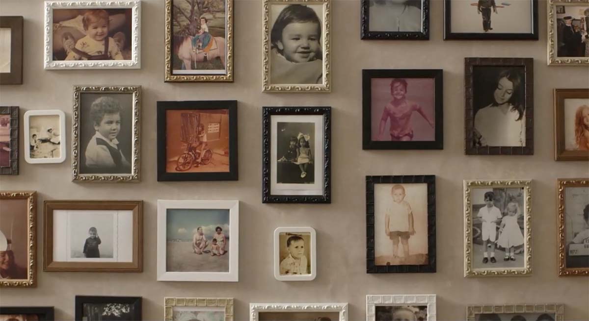 A shot showing framed pictures of several children, with a mix of colour and black-and-white.