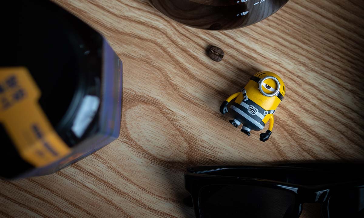 Yellow and black plastic toy on a wooden table