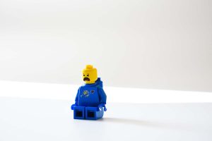blue lego minifig on a white surface