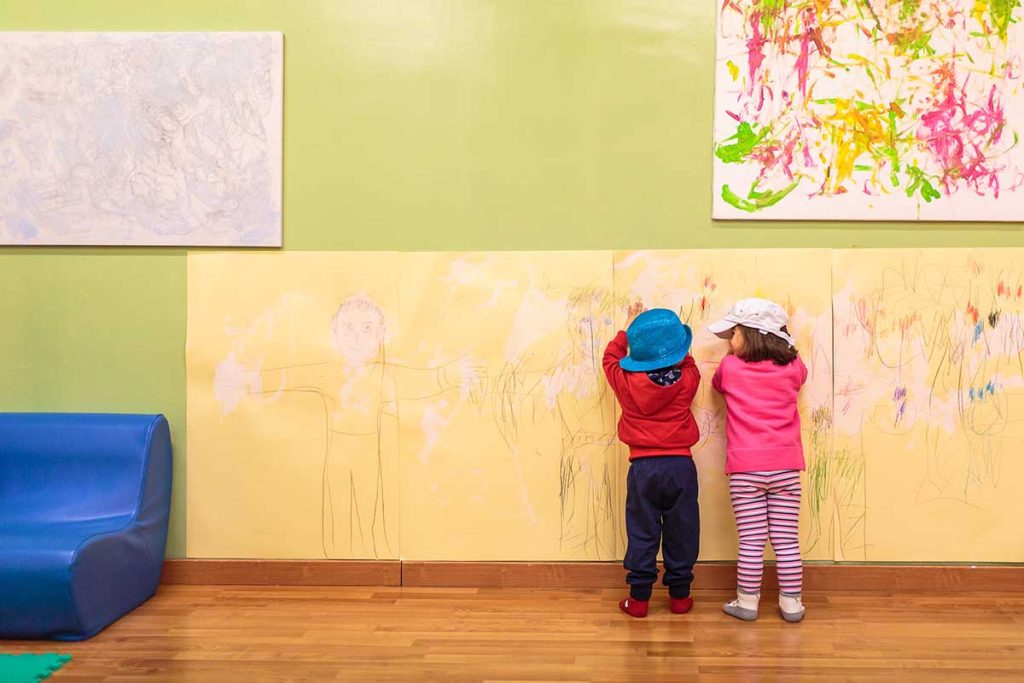 Children drawing on a wall